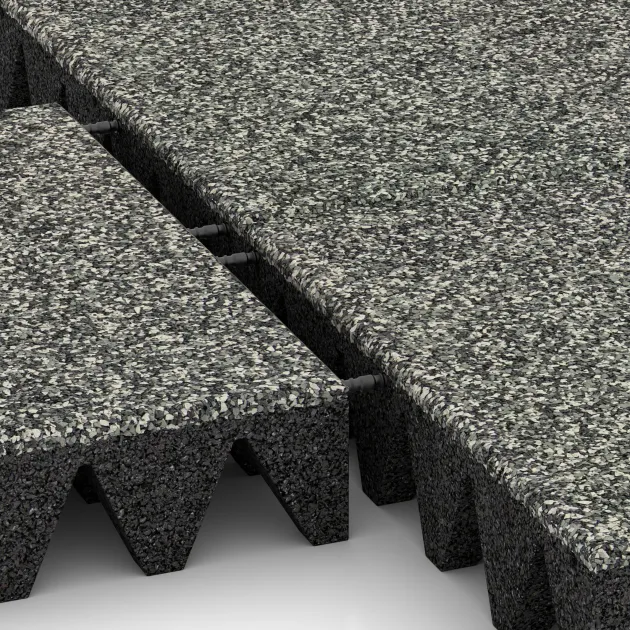 Großaufnahme vom Verbindungssystem von WARCO-Boden 5644 - Fallskyddsmattor 10 cm - EN 1177 ≤ 300 cm im Farbdesign Grå Granit. Abmessungen 500 x 500 x 100 mm.